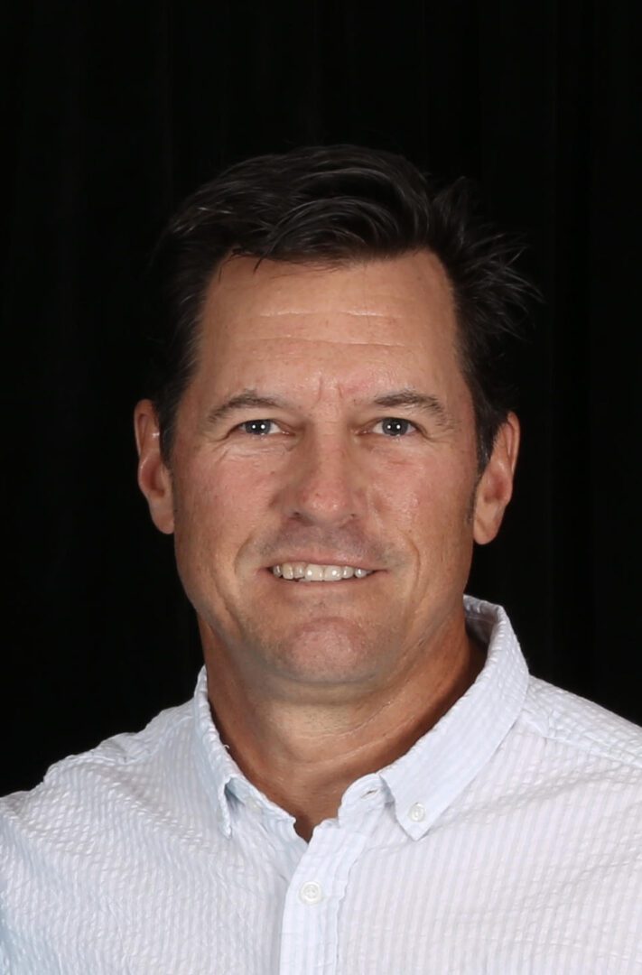 A man with a white shirt and black background